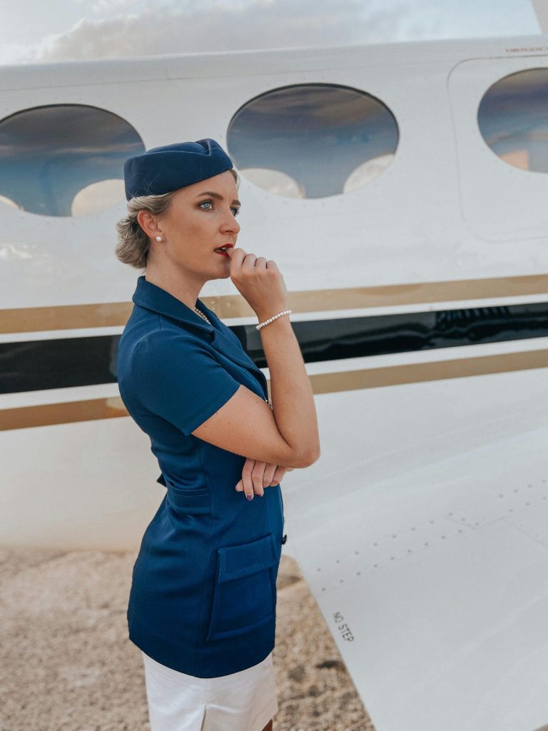 Air Stewardess Standing by Airplane